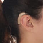 young woman with Hearing Aid closeup shot